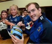 31 July 2013; Leinster's Devin Toner, signs a ball for Leo Branagh, age 10, from the Curragh Camp, during a Leinster Rugby Summer Camp at Cill Dara RFC, Kildare, Co. Kildare. Picture credit: David Maher / SPORTSFILE