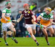 6 February 2022; Tom Monaghan of Galway in action against Ben Conneely and Roiss Ravenhill of Offaly during the Allianz Hurling League Division 1 Group A match between Galway and Offaly at Pearse Stadium in Galway. Photo by Ray Ryan/Sportsfile