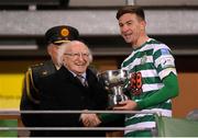 11 February 2022; Shamrock Rovers captain Ronan Finn is presented with the FAI President's Cup by President of Ireland Michael D Higgins after the match between Shamrock Rovers and St Patrick's Athletic at Tallaght Stadium in Dublin. Photo by Stephen McCarthy/Sportsfile