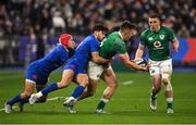 12 February 2022; Dan Sheehan of Ireland offloads to teammate Andrew Conway, right, as he is tackled by Gabin Villiere and Romain Ntamack of France during the Guinness Six Nations Rugby Championship match between France and Ireland at Stade de France in Paris, France. Photo by Seb Daly/Sportsfile
