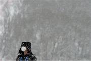 13 February 2022; A member of security watches on as snow falls during a break in the Men's Giant Slalom event on day nine of the Beijing 2022 Winter Olympic Games at National Alpine Skiing Centre in Yanqing, China. Photo by Ramsey Cardy/Sportsfile