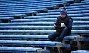 13 February 2022; A Tipperary supporter checks his mobile phone as he sits in the stand the Allianz Hurling League Division 1 Group B match between Tipperary and Kilkenny at FBD Semple Stadium in Thurles, Tipperary. Photo by Brendan Moran/Sportsfile