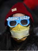14 February 2022; A supporter, wearing Beijing 2022 glasses, and a face covering, during the Men's Snowboard Big Air Qualification event on day 10 of the Beijing 2022 Winter Olympic Games at Big Air Shougang in Beijing, China. Photo by Ramsey Cardy/Sportsfile