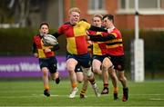 17 February 2022; Rory O’Connor O’Hehir of St Fintan's High School holds off the tackle of CBC Monkstown's Ben Sharpe during the Bank of Ireland Fr Godfrey Cup Semi-Final match between St Fintan's High School and CBC Monkstown at Clontarf Rugby Club in Dublin. Photo by Seb Daly/Sportsfile