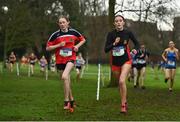 16 February 2022; Emma McCarthy of Presentation Wexford, left, and Isabelle Cuffe of Lucan Community College, competing in the junior girls' 2000m during the Irish Life Health Leinster Schools Cross Country Championships at Santry Demesne in Dublin. Photo by Sam Barnes/Sportsfile