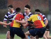 18 February 2022; Ultan Byrne of Terenure College is tackled by Cian Macari Kelly, left, and Daniel de Brun of St Fintan's during the Bank of Ireland Leinster Rugby Schools Senior Cup 1st Round match between Terenure College and St Fintan’s High School at Castle Avenue in Dublin. Photo by David Fitzgerald/Sportsfile