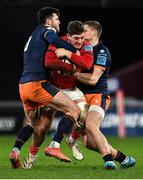 18 February 2022; Dan Goggin of Munster is tackled by James Lang and Blair Kinghorn of Edinburgh during the United Rugby Championship match between Munster and Edinburgh at Thomond Park in Limerick. Photo by Brendan Moran/Sportsfile
