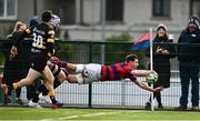 19 February 2022; Adrian D'Arcy of Clontarf dives over to score his side's third try during the Energia All-Ireland League Division 1A match between Clontarf and Young Munster at Castle Avenue in Dublin. Photo by Sam Barnes/Sportsfile