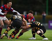 19 February 2022; Ivan Soroka of Clontarf is tackled by Bailey Faloon, left, and Alan Kennedy of Young Munster during the Energia All-Ireland League Division 1A match between Clontarf and Young Munster at Castle Avenue in Dublin. Photo by Sam Barnes/Sportsfile
