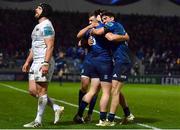 19 February 2022; James Lowe of Leinster, hidden, celebrates with teammates Luke McGrath, left, and Jimmy O'Brien after scoring his side's thrid try during the United Rugby Championship match between Leinster and Ospreys at RDS Arena in Dublin. Photo by David Fitzgerald/Sportsfile