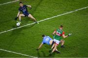 19 February 2022; Jack Carney of Mayo shoots to score his side's first goal despite the efforts of Dublin goalkeeper Evan Comerford during the Allianz Football League Division 1 match between Dublin and Mayo at Croke Park in Dublin. Photo by Stephen McCarthy/Sportsfile