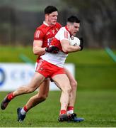 20 February 2022; Conor Doherty of Derry is tackled by Colm O'Callaghan of Cork during the Allianz Football League Division 2 match between Derry and Cork at Derry GAA Centre of Excellence in Owenbeg, Derry. Photo by Sam Barnes/Sportsfile