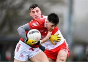 20 February 2022; Tadhg Corkery of Cork is tackled by Conor Doherty of Derry during the Allianz Football League Division 2 match between Derry and Cork at Derry GAA Centre of Excellence in Owenbeg, Derry. Photo by Sam Barnes/Sportsfile