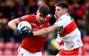 20 February 2022; Ian Maguire of Cork is tackled by Conor Doherty of Derry during the Allianz Football League Division 2 match between Derry and Cork at Derry GAA Centre of Excellence in Owenbeg, Derry. Photo by Sam Barnes/Sportsfile