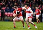 20 February 2022; Fionn Herlihy of Cork is tackled by Conor McCluskey of Derry during the Allianz Football League Division 2 match between Derry and Cork at Derry GAA Centre of Excellence in Owenbeg, Derry. Photo by Sam Barnes/Sportsfile