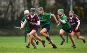 20 February 2022; Cliodhna Ni Mhianain of Slaughtneil in action against, from left, Joanne Daly, Kate Gallagher and Laura Ward of Sarsfields during the AIB All-Ireland Senior Camogie Club Championship Semi-Final match between Sarsfields and Slaughtneil at Naomh Eanna in Gorey, Wexford. Photo by Matt Browne/Sportsfile