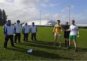 20 February 2022; Umpires look on as referee Maggie Farrelly poses for a picture with the two captains, David Bruen of Leitrim and Liam Gavaghan of London, before the Allianz Football League Division 4 match between Leitrim and London at Connacht GAA Centre of Excellence in Bekan, Mayo. Photo by Ray McManus/Sportsfile