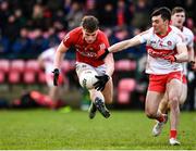 20 February 2022; Fionn Herlihy of Cork in action against Conor McCluskey of Derry  during the Allianz Football League Division 2 match between Derry and Cork at Derry GAA Centre of Excellence in Owenbeg, Derry. Photo by Sam Barnes/Sportsfile