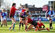 24 February 2022; Ciara Short of South East is tackled by North East's Jade Gaffney, left, Aoife Purcell and Isabele Beretonduring the Bank of Ireland Leinster Rugby Sarah Robinson Cup Round 3 match between South East and North East at Energia Park in Dublin. Photo by Seb Daly/Sportsfile