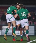 25 February 2022; Chay Mullins of Ireland, centre, celebrates with teammates Dylan O’Grady and Patrick Campbell after scoring their side's fourth try during the Guinness U20 Six Nations Rugby Championship match between Ireland and Italy at Musgrave Park in Cork. Photo by Brendan Moran/Sportsfile
