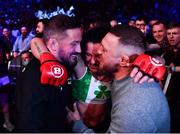 25 February 2022; Sinead Kavanagh celebrates as she is carried out of the cage by coach John Kavanagh, left, and Conor McGregor after defeating Leah McCourt in their women's featherweight bout at Bellator 275 at the 3Arena in Dublin. Photo by David Fitzgerald/Sportsfile