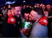 25 February 2022; Sinead Kavanagh celebrates as she is carried out of the cage by coach John Kavanagh, left, and Conor McGregor after defeating Leah McCourt in their women's featherweight bout at Bellator 275 at the 3Arena in Dublin. Photo by David Fitzgerald/Sportsfile