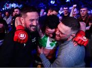 25 February 2022; Sinead Kavanagh celebrates as she is carried out of the cage by coach John Kavanagh, left, and Conor McGregor after defeating Leah McCourt in their women's featherweight bout at Bellator 275 at the 3Arena in Dublin. Photo by David Fitzgerald/Sportsfile