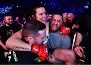 25 February 2022; Sinead Kavanagh celebrates as she is carried out of the cage by coach John Kavanagh, left, and Conor McGregor after defeating Leah McCourt in their women's featherweight bout at Bellator 275 at the 3Arena in Dublin. Photo by David Fitzgerald/Sportsfile