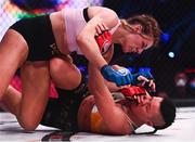 25 February 2022; Leah McCourt, top, in action against Sinead Kavanagh during their women's featherweight bout at Bellator 275 at the 3Arena in Dublin. Photo by David Fitzgerald/Sportsfile