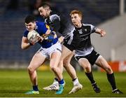 26 February 2022; Sean O'Connor of Tipperary in action against Paul Kilcoyne, centre, and Sean Carrabine of Sligo during the Allianz Football League Division 4 match between Tipperary and Sligo at FBD Semple Stadium in Thurles, Tipperary. Photo by David Fitzgerald/Sportsfile