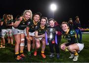 26 February 2022; Railway Union players, from left, Chloe Blackmore, Anna McGann, captain Niamh Byrne and Nikki Caughey celebrate with supporter Jennifer Malone after the Energia Women's All-Ireland League Final match between Blackrock College and Railway Union at Energia Park in Dublin. Photo by Ben McShane/Sportsfile