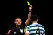 25 February 2022; Referee Robert Hennessy shows a yellow card to Roberto Lopes of Shamrock Rovers during the SSE Airtricity League Premier Division match between Derry City and Shamrock Rovers at The Ryan McBride Brandywell Stadium in Derry. Photo by Stephen McCarthy/Sportsfile