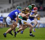 27 February 2022; Martin Keoghan of Kilkenny is tackled by Seán Downey of Laois during the Allianz Hurling League Division 1 Group B match between Kilkenny and Laois at UPMC Nowlan Park in Kilkenny. Photo by Ray McManus/Sportsfile