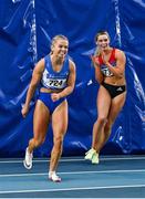 27 February 2022; Molly Scott of St Laurence O'Toole AC, Carlow, left, celebrates winning the senior women's 60m final in a national record time of 7.19, after the final had to be re-run  during day two of the Irish Life Health National Senior Indoor Athletics Championships at the National Indoor Arena at the Sport Ireland Campus in Dublin. Photo by Sam Barnes/Sportsfile