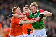 27 February 2022; Padraig O'Hora of Mayo is tackled by Ciaran Mackin of Armagh during the Allianz Football League Division 1 match between Mayo and Armagh at Dr Hyde Park in Roscommon. Photo by Ramsey Cardy/Sportsfile