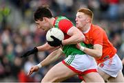 27 February 2022; Diarmuid O'Connor of Mayo is tackled by Ciaran Mackin of Armagh during the Allianz Football League Division 1 match between Mayo and Armagh at Dr Hyde Park in Roscommon. Photo by Ramsey Cardy/Sportsfile