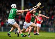 27 February 2022; Sean O’Donoghue of Cork is tackled by Aaron Gillane, left, and Darragh O'Donovan of Limerick during the Allianz Hurling League Division 1 Group A match between Limerick and Cork at TUS Gaelic Grounds in Limerick. Photo by Eóin Noonan/Sportsfile