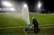 28 February 2022; Tony Sheridan of the UCD groundstaff attempts to stop a sprinkler with a wheelbarrow during the SSE Airtricity League Premier Division match between UCD and Shelbourne at UCD Bowl in Belfield, Dublin. Photo by Harry Murphy/Sportsfile