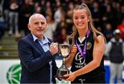 1 March 2022; Gaelcholáiste Tralee captain Paris Nic Cárthaigh is presented with the cup by Baskeball Ireland southwest regional organiser Ger Tarrant after the Basketball Ireland U19B Girls Schools League Final match between St. Louis Kiltimagh, Mayo and Gaelcholáiste Tralee, Kerry at National Basketball Arena in Dublin. Photo by Brendan Moran/Sportsfile