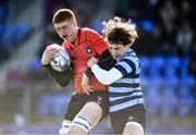 1 March 2022; Eamon Burke of St Michaels is tackled by Daire McCarthy of St Vincents Castleknock during the Bank of Ireland Leinster Rugby Schools Junior Cup 1st Round match between St Vincent’s Castleknock College, Dublin, and St Michael’s College, Dublin, at Energia Park in Dublin. Photo by David Fitzgerald/Sportsfile