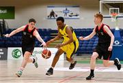 2 March 2022; Michee Bueno of Kishoge in action against Michael Kelly, left, and Michael Galvin of St Michael's Listowel during the Basketball Ireland U16C Boys Schools League Final match between Kishoge Community College, Dublin, and St Michael's College Listowel, Kerry, at the National Basketball Arena in Dublin. Photo by Seb Daly/Sportsfile