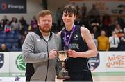 2 March 2022; Rathmore Grammar School captain Jacob Byrne is presented with the cup by Daryl Lambe, competitions manager, Basketball Ireland, after the Basketball Ireland U16B Boys Schools League Final match between Skibbereen Community School, Cork, and Rathmore Grammar School, Belfast, at the National Basketball Arena in Dublin. Photo by Seb Daly/Sportsfile