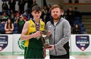 2 March 2022; Gortnor Abbey captain Niall Coggins is presented with the cup Daryl Lambe, competitions manager, Basketball Ireland, after the Basketball Ireland U19B Boys Schools League Final match between Gortnor Abbey Secondary School, Mayo, and St Munchin's College, Limerick, at the National Basketball Arena in Dublin. Photo by Seb Daly/Sportsfile