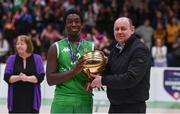 3 March 2022; Alvin Olagemi of Calasanctius College is presented the MVP by Basketball Ireland president PJ Reidy after the Basketball Ireland U16A Boys Schools League Final match between Calasanctius College, Galway and SPSL Rathmore, Kerry at the National Basketball Arena in Dublin. Photo by Ben McShane/Sportsfile