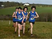 3 March 2022; Competitors in the senior boys 6000m and team mates, from left, Niall Murphy, Dylan Casey and Dean Casey of St Flannans Ennis, competing in the senior boys 6000m during the Irish Life Health Munster Schools Cross Country Championships at Riverstick, Boulaling, Cork. Photo by David Fitzgerald/Sportsfile