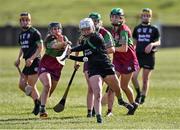 5 March 2022; Patrice Duggan of Clanmaurice in action against Megan Kerr of Eoghan Rua during the 2021 AIB Junior Club Camogie A Championship Final match between Clanmaurice, Kerry, and Eoghan Rua, Derry, at O'Raghallaigh's GAA club in Drogheda, Louth. Photo by Piaras Ó Mídheach/Sportsfile