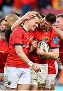 5 March 2022; Jack O’Donoghue of Munster, right, celebrates with teammate Mike Haley after scoring their side's third try during the United Rugby Championship match between Munster and Dragons at Thomond Park in Limerick. Photo by Seb Daly/Sportsfile