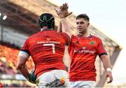 5 March 2022; Chris Cloete of Munster, left, celebrates with teammate Jack Crowley after scoring their side's fourth try during the United Rugby Championship match between Munster and Dragons at Thomond Park in Limerick. Photo by Seb Daly/Sportsfile
