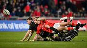 5 March 2022; Mike Haley of Munster is tackled by Jack Dixon, left, and Josh Lewis of Dragons during the United Rugby Championship match between Munster and Dragons at Thomond Park in Limerick. Photo by Seb Daly/Sportsfile