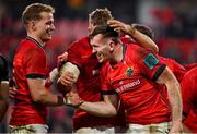 5 March 2022; Chris Farrell of Munster, centre, celebrates with teammate Mike Haley, left, after scoring their side's sixth try during the United Rugby Championship match between Munster and Dragons at Thomond Park in Limerick. Photo by Brendan Moran/Sportsfile